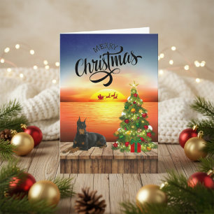 Carte de coucher de soleil de Noël Doberman