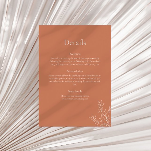 Carte de détails botaniques en terre cuite foncée (Dark Terracotta Botanical Details Card on a sunny neutral dry palm leaf.)