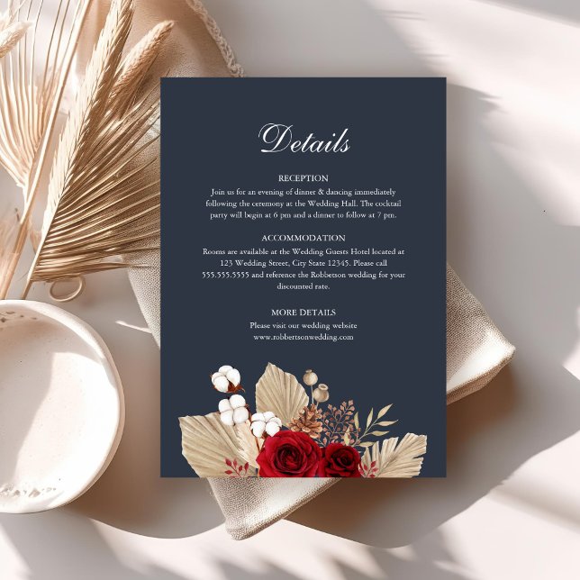 Carte de détails de mariage avec des roses de Bour (Midnight Blue Burgundy Roses Wedding Details Card on a boho table with dry palm leaf.)
