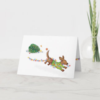 Carte de Noël d'un mignon teckel avec des lumières