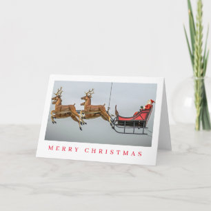 Carte de Noël père Noël et figurine de traîneau