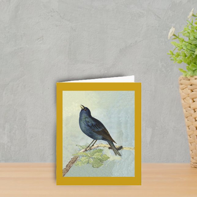 Carte de note d'aquarelle de merle de chant (Elegant singing blackbird on branch with caterpillar leaves on dark golden yellow boder notcard.)