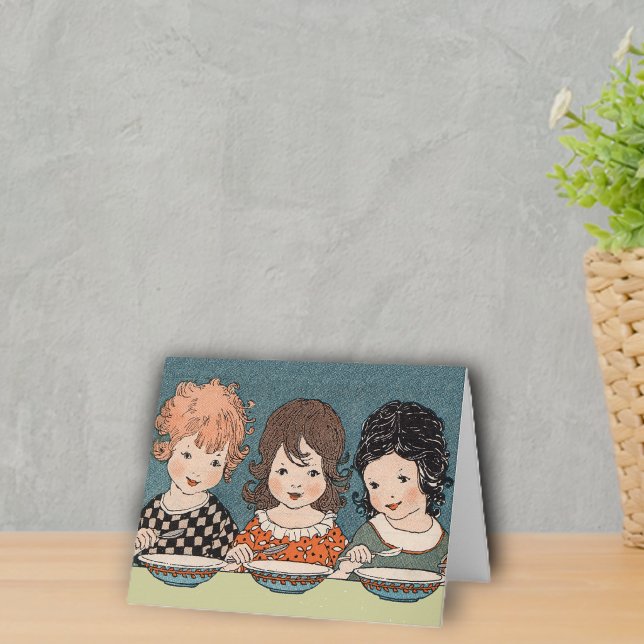 Carte de trois petites soeurs (Three sisters different coloured hair sitting at table eating soup on notecards.)