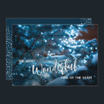 Carte de vacances Blue Christmas Tree<br><div class="desc">Un beau sapin de Noël enneigé reflète les lumières bleues de la soirée avec "Le plus merveilleux moment de l'année" sur le devant et votre salut de vacances personnel sur le dos. Sélectionnez Matte pour le papier le plus lourd et la haute définition pour une meilleure qualité d'impression.</div>