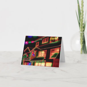 Carte de vœux avec maison illuminée pour Noël