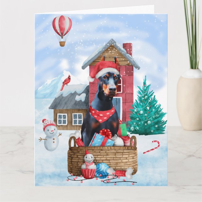 Carte Doberman dans une maison de Noël enneigée pour chi (Devant)
