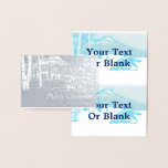 Carte Dorée Loup solitaire dans WInter<br><div class="desc">Un loup (Canis lupus) traverse un paysage enneigé de bouleaux et de montagnes sur cette image stylisée et monotone bleue. Le texte "Joyeux Noël" apparaît également. Ajoutez votre propre texte supplémentaire.</div>