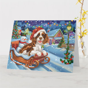 Carte Épaniel breton dans un traîneau enneigé à Noël