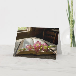 Carte Glaïeul rose de sympathie sur une Sainte Bible ouv