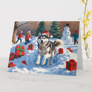 Carte Husky sibérien courant dans la neige avec un chape