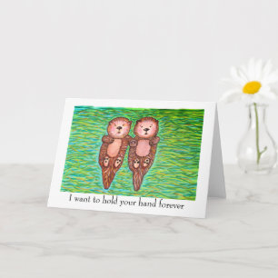 Carte "je t'aime" avec deux loutres se tenant la m