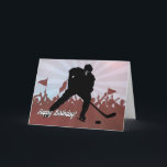 Carte Joueur de hockey Silhouette pour l'anniversaire<br><div class="desc">Un joueur de hockey en silhouette se prépare à marquer devant une foule en rugissement tenant des drapeaux avec un arrière - plan en plein soleil. Une carte parfaite pour offrir un fan de hockey pour leur journée spéciale. Design © 2015 Julia Bryant.</div>