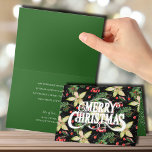 Carte Joyeux Noël Poinsettias<br><div class="desc">Joyeux Noël sur un arrière - plan de poinsettias blanches,  feuilles et baies sur noir sont présentés sur ces cartes de voeux de Noël pliées. CORRESPONDANCE d'objets dans notre collection.</div>