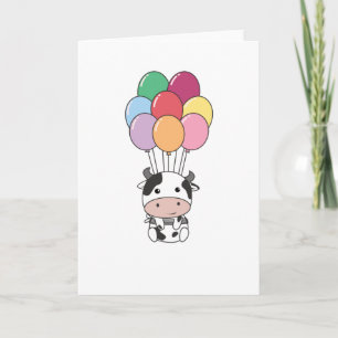 Carte La vache s'envole avec des ballons colorés