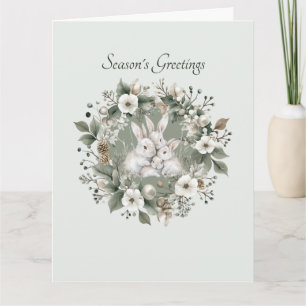Carte Lapins mignons dans une couronne florale hivernale