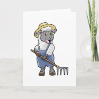 Mouton en agriculteur avec râteau et chapeau
