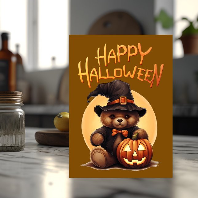 Carte Ours en peluche Halloween (Halloween card with teddy bear on the front sits on top of a kitchen counter.)