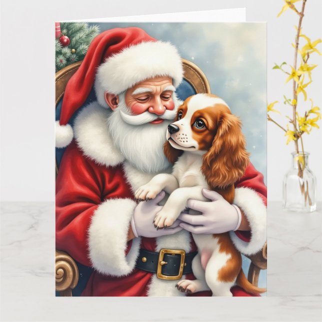 Carte Père Noël tenant un Cavalier King Charles Spaniel (Fleur jaune)