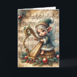 Carte Pixie Fairy de Noël Jouer une harpe<br><div class="desc">Une fée délicate ornée d'accents floraux joue une harpe contre un arrière - plan de notes musicales Texte à changer.</div>