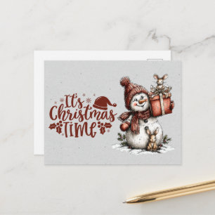 Carte Postale C'est Noël Bonhomme de neige tenant un cadeau et u