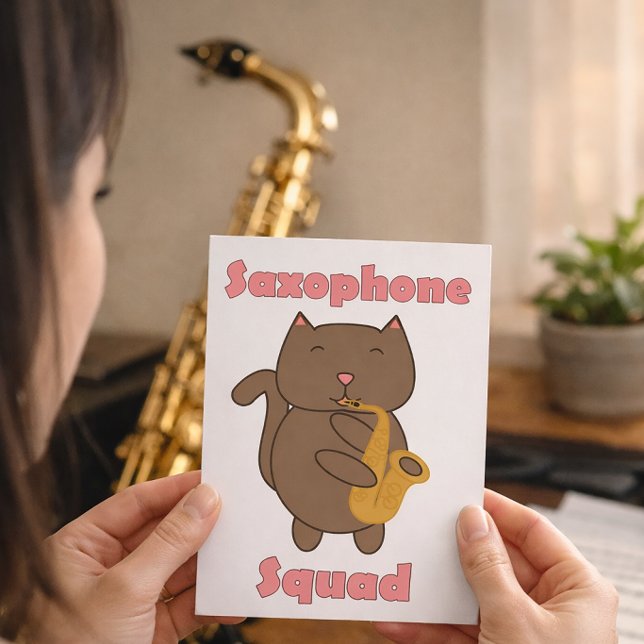 Carte Postale Chat Mignon Jouant du Saxophone “Saxophone Squad”  (A postcard with a cat playing the saxophone and the words saxophone squad.)