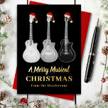 Carte Postale De Vacances En Aluminium Guitare cool Joyeux Noël Or personnalisé<br><div class="desc">Noël vient d'avoir cool et de la musique avec cette guitare amoureux de la musique joyeuse personnalisée Noël carte de fête de la typographie or personnalisée. Trois guitares semi acoustiques monochromatiques gris noir style art noir, portant des chapeaux santa, complètent ce design amusant et unique dessiné à la main. Oeuvre...</div>