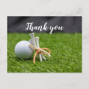 Carte Postale Golf ball et tee are on green grass merci