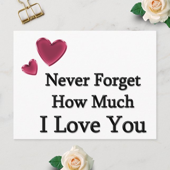 Carte Postale Je t'aime (Postcard showing Never Forget How Much I Love You with two hearts, laid flat on a white surface.)