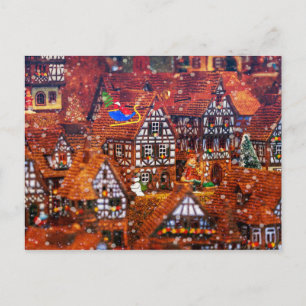 Carte Postale Le Père Noël survole un village de pain d'épices