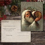 Carte Postale Père vintage Noël en neige avec Yule Log<br><div class="desc">Vintage artistique Robert Finlay McIntyre portrait du père Noël à la robe blanche portant une bille de Yule dans la neige. Le verso comporte un arrière - plan sépia complémentaire avec des champs de texte modifiables.</div>