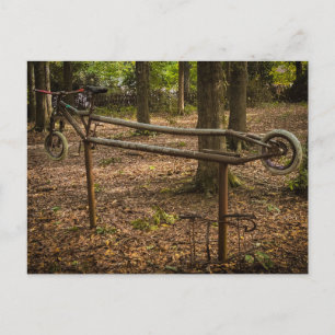 Carte Postale Sculpture de cadre de vélo rouillé dans les bois