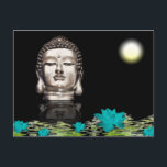 Carte Postale Statue de la tête de Bouddha<br><div class="desc">Une statue de Buddha head silver reflecting on black water filled with floating turquoise lotus flowers and green lily pads. Black background.</div>
