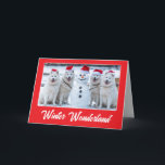 Carte Samoyeds et Snowman<br><div class="desc">Quatre Samoyeds portant des chapeaux de Père Noël posent fièrement avec un bonhomme de neige qu'ils ont construit.</div>