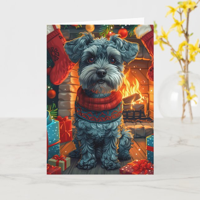 Carte Schnauzer avec des cadeaux de Noël devant une chem (Fleur jaune)