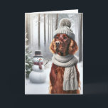 Carte Setter irlandais de Noël avec Snowman<br><div class="desc">Un chien portant un casquette tricoté gris et une écharpe se tient dans une forêt enneigée à côté d'un bonhomme de neige pour Noël</div>
