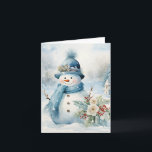 Carte Snowman Bleu Casquette Écarf Neige Arbres couverts<br><div class="desc">Adorable bonhomme de neige en bleu casquette et foulard à côté de jolies fleurs et saint en cette journée froide d'hiver.</div>