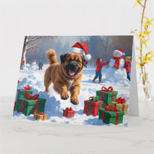 Carte Tibetan Mastiff courant dans la neige avec un chap