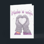 Carte Winter Make A Wish Féminin<br><div class="desc">L'image représente une illustration cosy et fantaisiste sur le thème de l'hiver. Elle montre deux mains portant des gants tricotés gris tenant un cœur blanc lumineux fait de neige. Le cœur est parsemé de petites étoiles et de points de différentes nuances de blanc, rose et violet, donnant une atmosphère rêveuse...</div>
