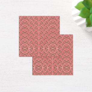 Cartes De Visite Un tapis aux motifs rouges et roses présente un dé