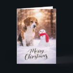 Cartes Pour Fêtes Annuelles Beagle Christmas Snowman Card<br><div class="desc">A charming Christmas card featuring a Beagle sitting in fresh winter snow beside a cheerful little snowman wrapped in a red scarf. Warm golden winter light and softly falling snow create a peaceful holiday moment that perfectly captures the curiosity and gentle nature Beagles are known for. This card is perfect...</div>