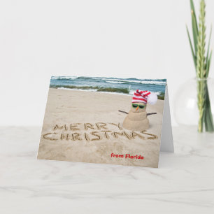 Cartes Pour Fêtes Annuelles Bonhomme de neige en sable sur la plage avec l'océ