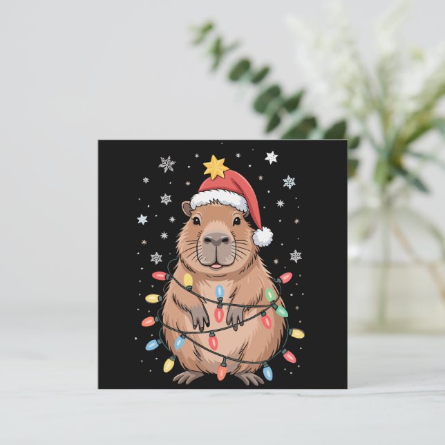 Cartes Pour Fêtes Annuelles Capybara de Noël avec chapeau de Père Noël lumière (Debout devant)