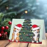 Cartes Pour Fêtes Annuelles Deux Corgi Christmas Tree Chien Santa Hat Cute<br><div class="desc">Ces magnifiques corgi gallois de Pembroke ont la tête inclinée à l'intérieur d'un mignon casquette du Père Noël. Les deux petits sont assis devant un joli sapin de Noël orné de décorations colorées. Une belle carte de vacances corgis avec un magnifique dessin d'un tricolore et une paire de corgi rouge...</div>