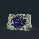 Cartes Pour Fêtes Annuelles Gilded Greenery | Joyeux Noël<br><div class="desc">Cette élégante carte de vœux de Noël présente une couronne encadrée de feuilles et de baies aquarelles modernes vertes,  rouges et dorées avec une typographie script dorée tendance sur un fond bleu marine foncé.</div>