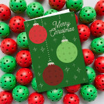 Cartes Pour Fêtes Annuelles Ornements de Pickleball rouges et verts de texte p<br><div class="desc">Le message sur le devant et à l'intérieur de cette carte de vacances peut être personnalisé avec votre propre texte. Cette carte présente des pickleballs déguisés en ornements de Noël. Mes illustrations d'ornements de pickleball sont en rouge, vert clair et bordeaux sur un fond vert foncé illustré de formes d'étoiles...</div>