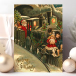 Cartes Pour Fêtes Annuelles Train de voeux de Noël Vintage<br><div class="desc">Belle carte postale du train de Noël vintage. "voeux de Noël" écrit dans le coin inférieur gauche. Cette conception comprend un chef de train du Père Noël avec deux petits enfants qui montent à l'avant du train.</div>