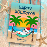 Cartes Pour Fêtes Annuelles Tropical Beach Père Noël Hammock Noël<br><div class="desc">La carte de Noël tropicale et côtière présente Père Noël se relaxant dans un hamac sur la plage, profitant des vagues de l'océan et d'un coucher de soleil coloré et des palmiers festifs plantés de lampadaires. Le meilleur salut dit "Joyeuses fêtes" en bleu marine. L'accueil dans le sable et le...</div>