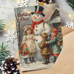 Cartes Pour Fêtes Annuelles Vintage Snowman de Noël avec des enfants en neige<br><div class="desc">Célébrez la magie de Noël avec cette carte vintage délicieuse avec un bonhomme de neige classique entouré d'enfants joyeux. Parfait pour envoyer des voeux de vacances chaleureux à la famille et à des amis!</div>