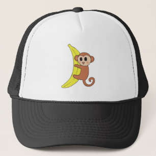 Casquette bébé singe mignon sur une banane