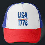 CASQUETTE USA 1776<br><div class="desc">USA et 1776 dans une police unique est imprimé sur ce chapeau de camionneur unisexe surligné de rayures rouges et bleues et d'une étoile d'or.</div>